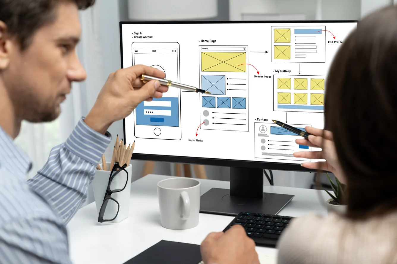 UI/UX design team collaborating on wireframes and interface layouts